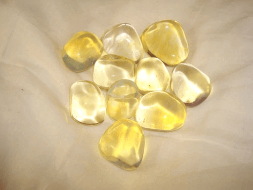 pieces of smooth yellow gem stones brown cloth background
