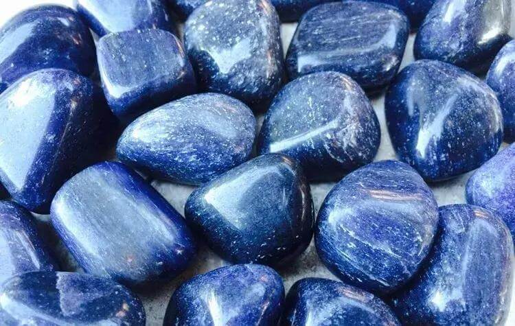 many pieces of smooth blue stones close up view