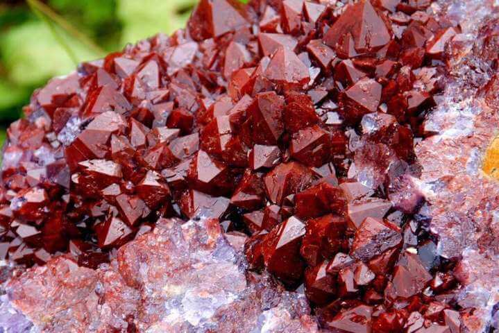 jagged slab of red crystal rock close up view details