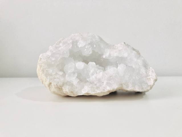 one raw unpolished white geode white background close up view
