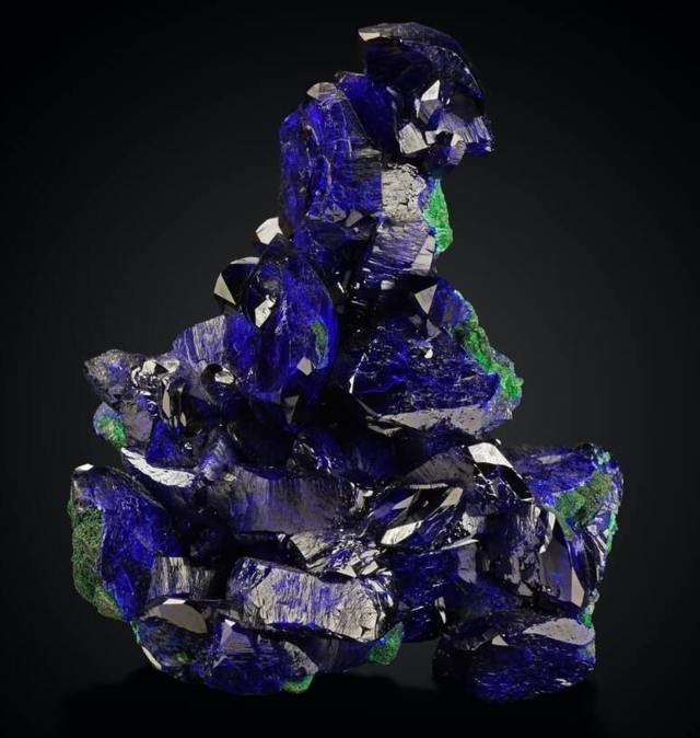 blue polished crystal on a black background close up view