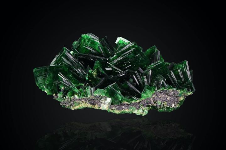 deep green geode crystal black background close up view