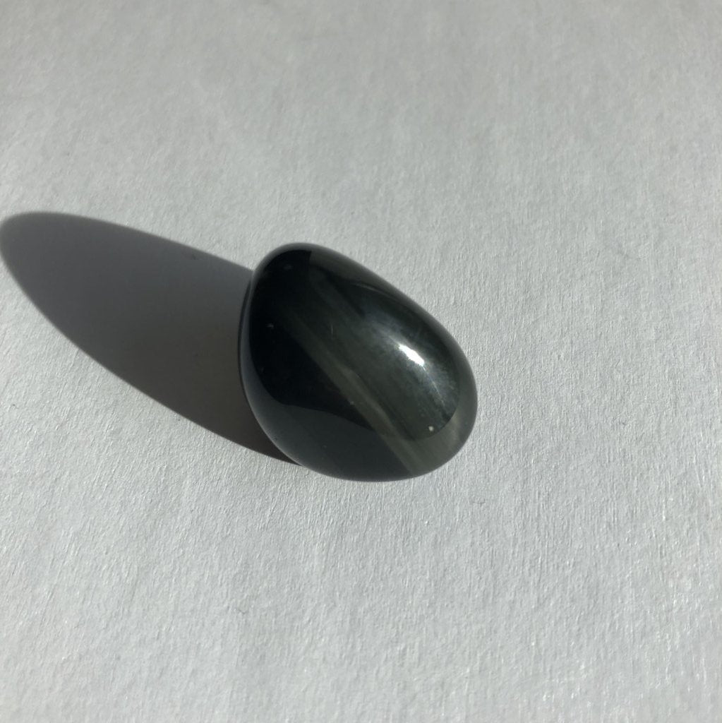 Black Obsidian Tumbled Crystal on a white background