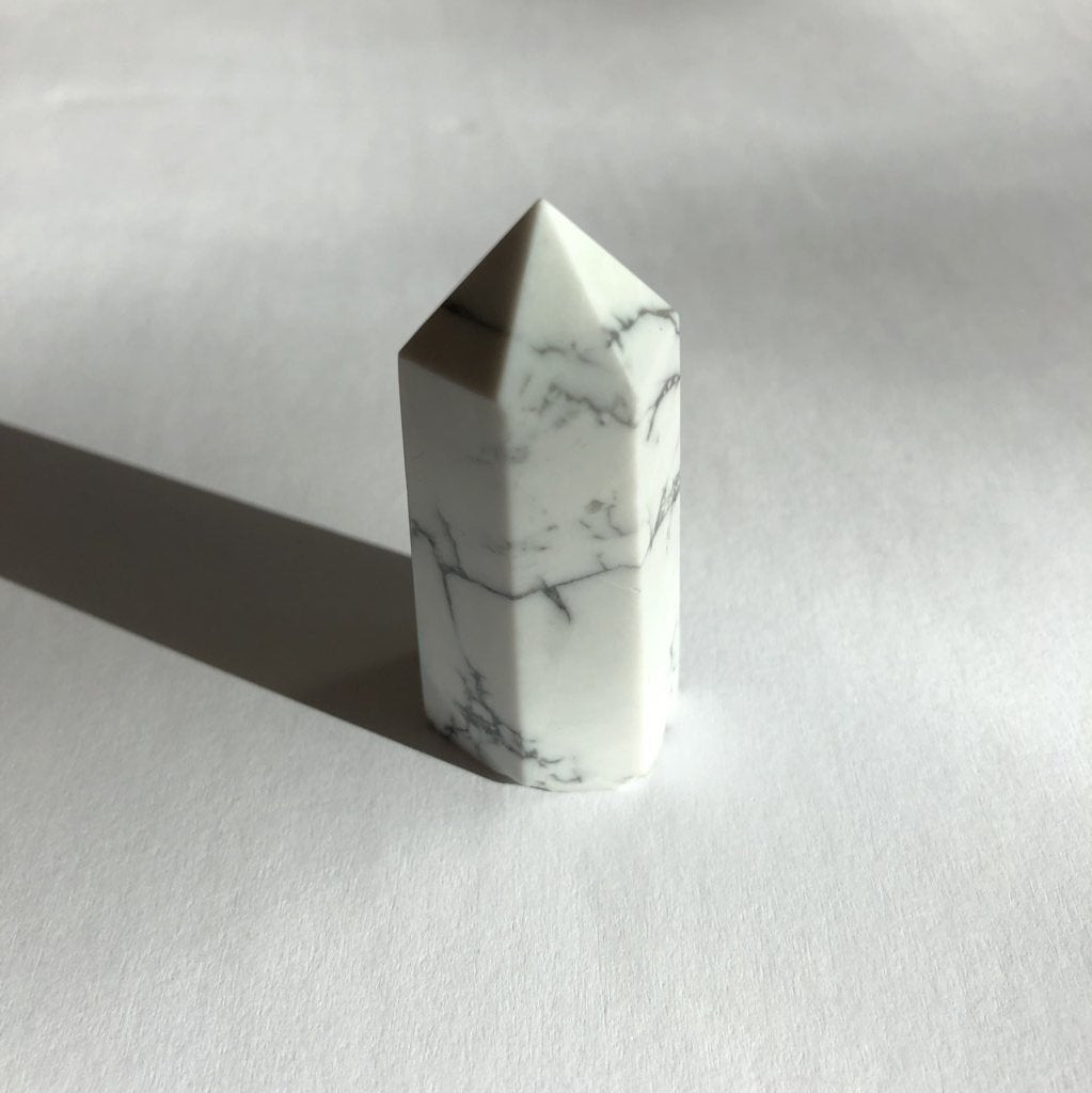 Howlite Point crystal on white background