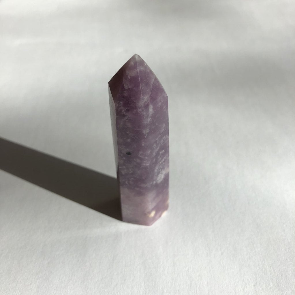 Lepidolite Point crystal on white background