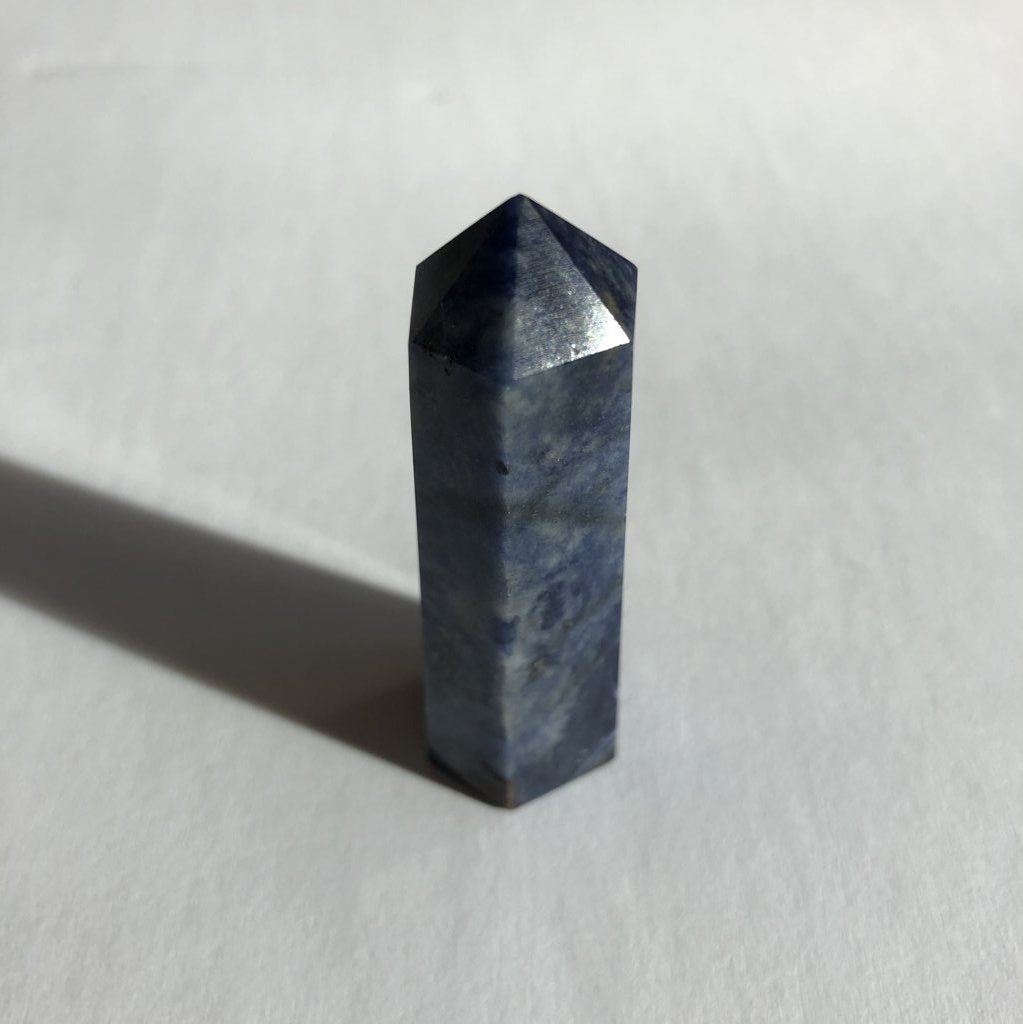 Sodalite Point crystal on white background